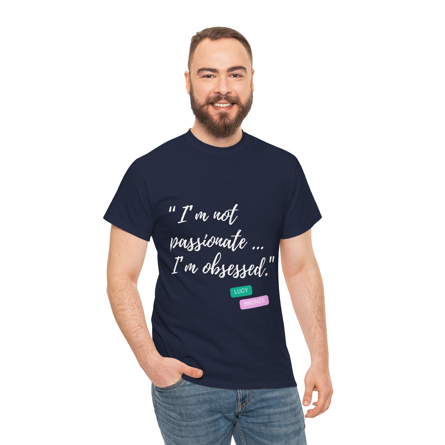 Unisex heavy cotton T-shirt with bold “Not Passion. Obsession.” text design, inspired by the ethos of being Unapologetically Obsessed. Available in charcoal, black, light pink, navy, and sport grey. Emphasizes quality, comfort, and the story of autism and ADHD empowerment tied to the Lioness icon.