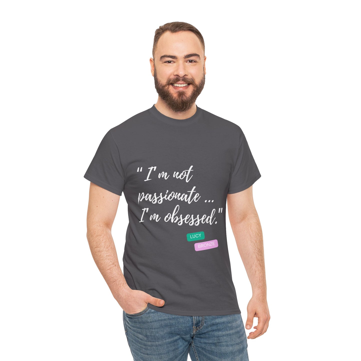 Unisex heavy cotton T-shirt with bold “Not Passion. Obsession.” text design, inspired by the ethos of being Unapologetically Obsessed. Available in charcoal, black, light pink, navy, and sport grey. Emphasizes quality, comfort, and the story of autism and ADHD empowerment tied to the Lioness icon.