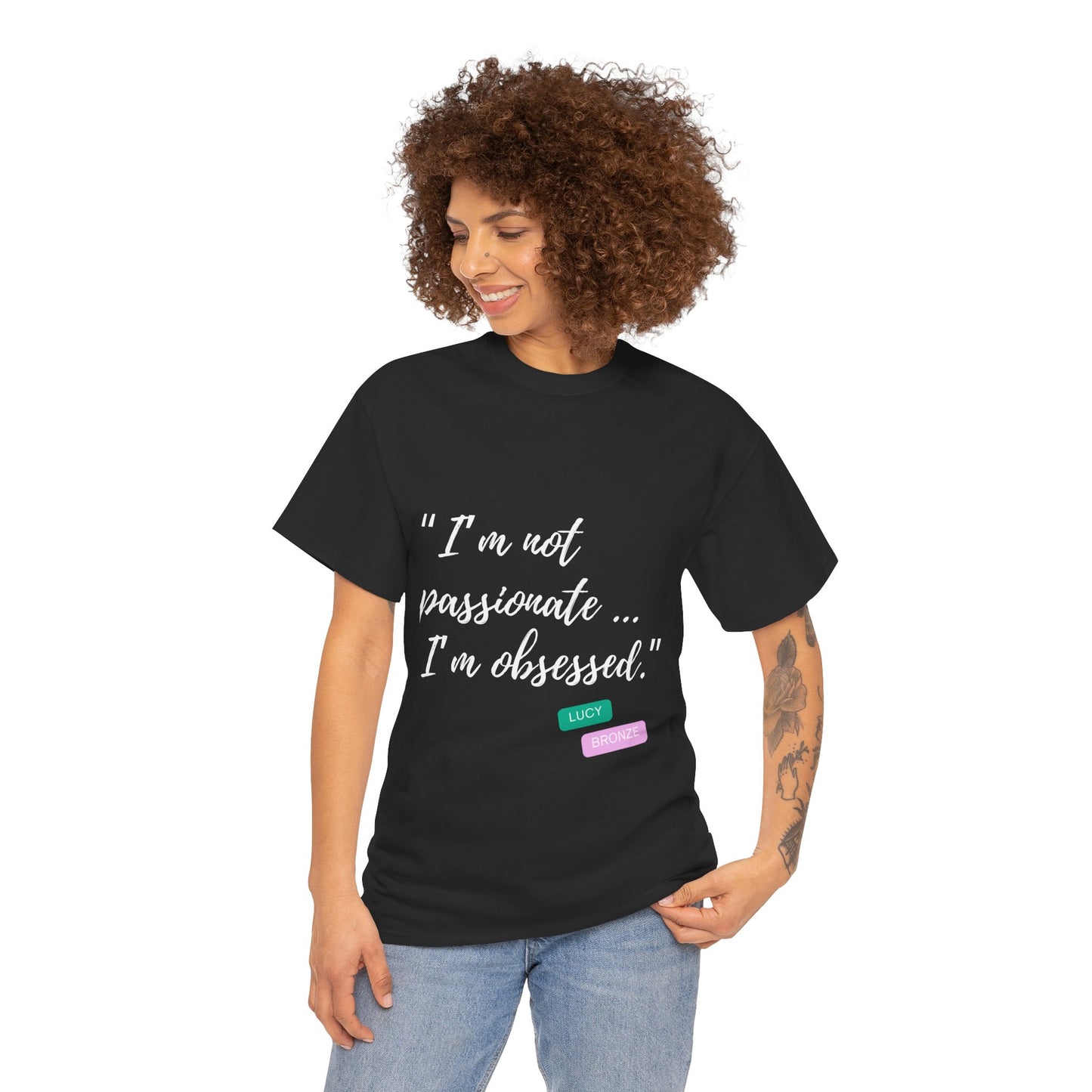 Unisex heavy cotton T-shirt with bold “Not Passion. Obsession.” text design, inspired by the ethos of being Unapologetically Obsessed. Available in charcoal, black, light pink, navy, and sport grey. Emphasizes quality, comfort, and the story of autism and ADHD empowerment tied to the Lioness icon.