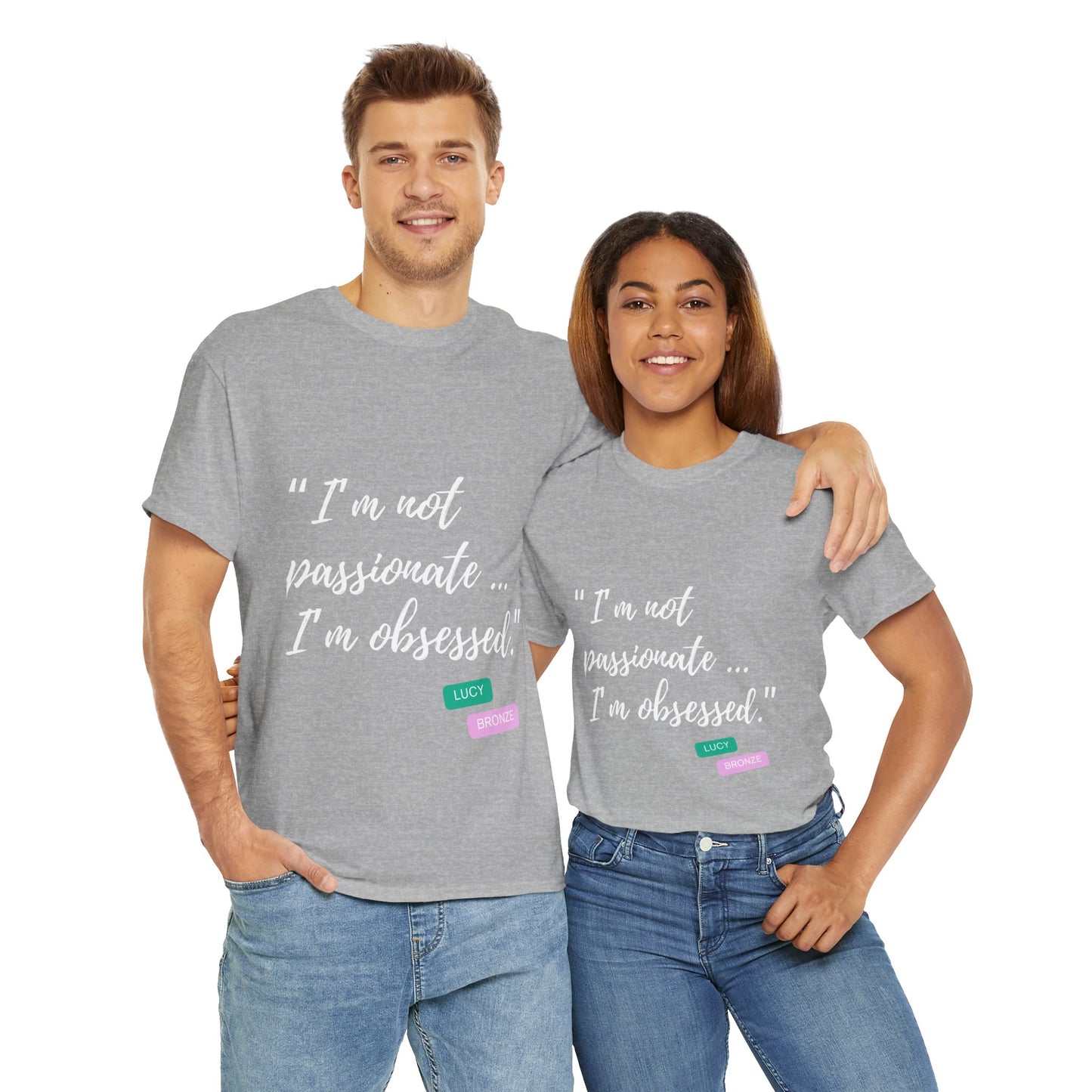 Unisex heavy cotton T-shirt with bold “Not Passion. Obsession.” text design, inspired by the ethos of being Unapologetically Obsessed. Available in charcoal, black, light pink, navy, and sport grey. Emphasizes quality, comfort, and the story of autism and ADHD empowerment tied to the Lioness icon.