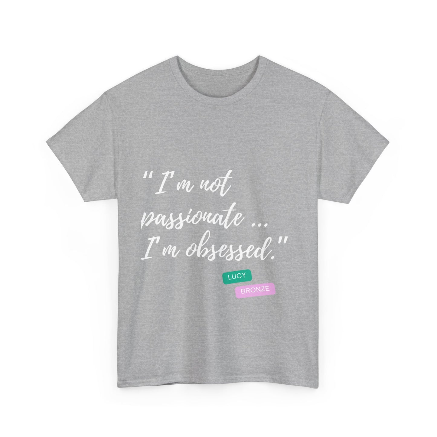 Unisex heavy cotton T-shirt with bold “Not Passion. Obsession.” text design, inspired by the ethos of being Unapologetically Obsessed. Available in charcoal, black, light pink, navy, and sport grey. Emphasizes quality, comfort, and the story of autism and ADHD empowerment tied to the Lioness icon.