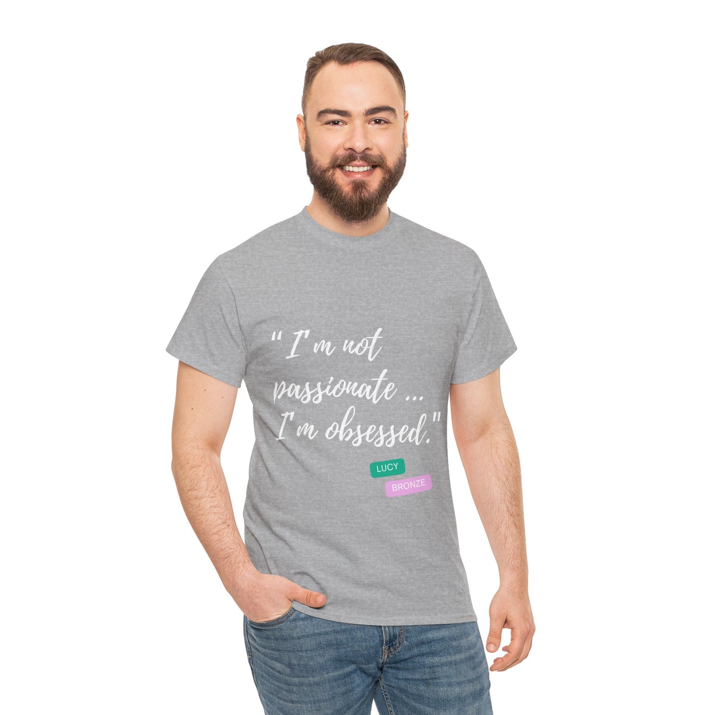 Unisex heavy cotton T-shirt with bold “Not Passion. Obsession.” text design, inspired by the ethos of being Unapologetically Obsessed. Available in charcoal, black, light pink, navy, and sport grey. Emphasizes quality, comfort, and the story of autism and ADHD empowerment tied to the Lioness icon.