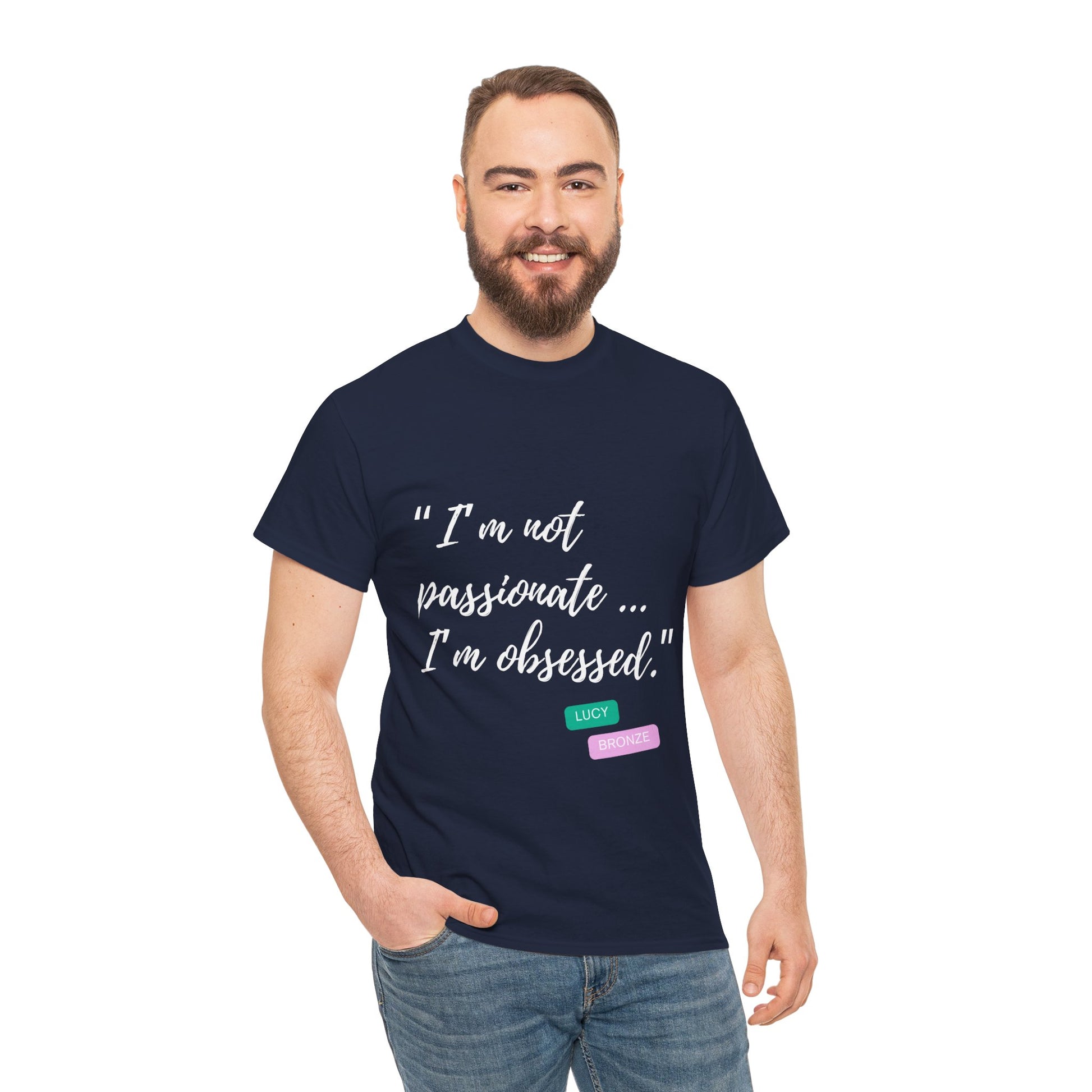 Unisex heavy cotton T-shirt with bold “Not Passion. Obsession.” text design, inspired by the ethos of being Unapologetically Obsessed. Available in charcoal, black, light pink, navy, and sport grey. Emphasizes quality, comfort, and the story of autism and ADHD empowerment tied to the Lioness icon.