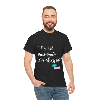 Unisex heavy cotton T-shirt with bold “Not Passion. Obsession.” text design, inspired by the ethos of being Unapologetically Obsessed. Available in charcoal, black, light pink, navy, and sport grey. Emphasizes quality, comfort, and the story of autism and ADHD empowerment tied to the Lioness icon.