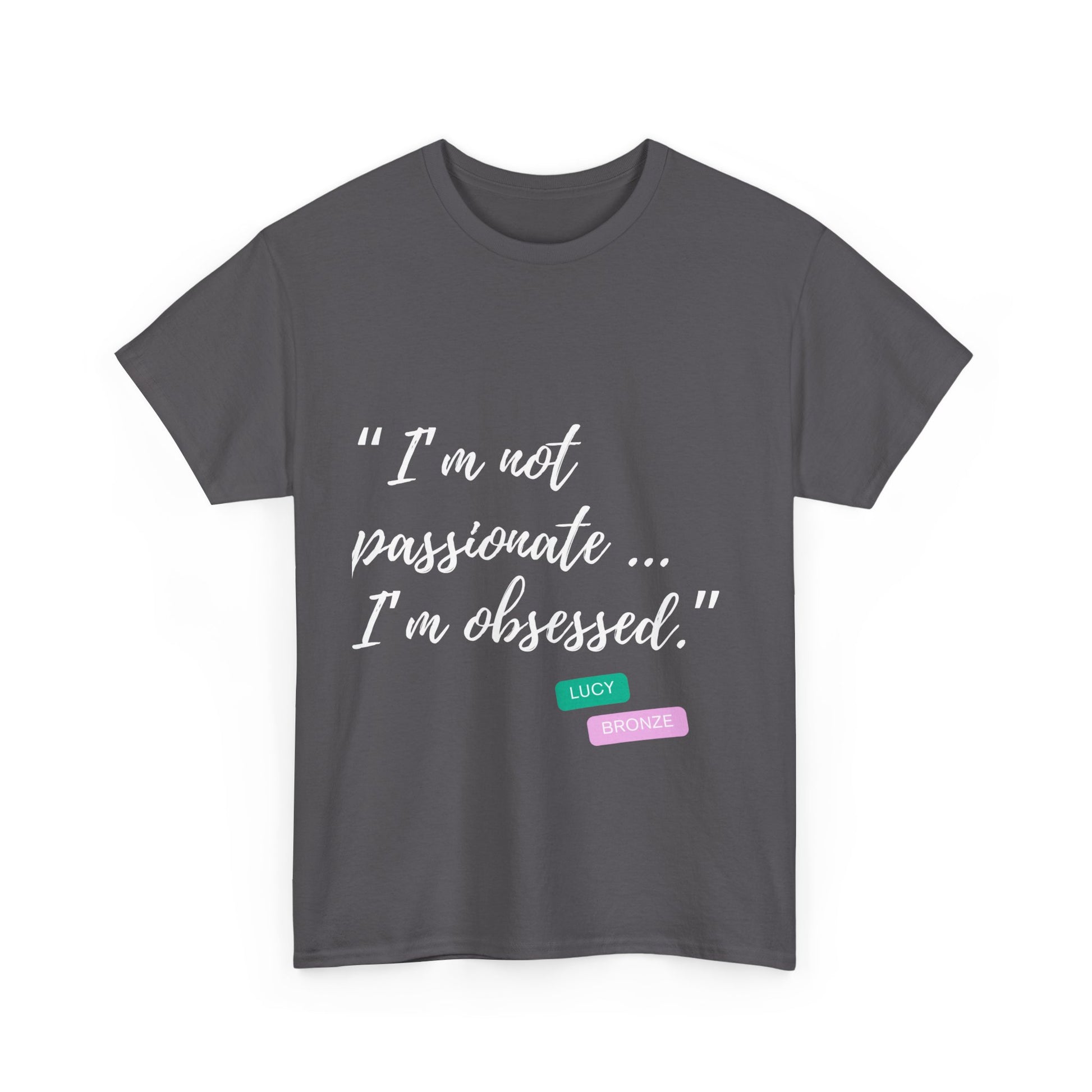 Unisex heavy cotton T-shirt with bold “Not Passion. Obsession.” text design, inspired by the ethos of being Unapologetically Obsessed. Available in charcoal, black, light pink, navy, and sport grey. Emphasizes quality, comfort, and the story of autism and ADHD empowerment tied to the Lioness icon.