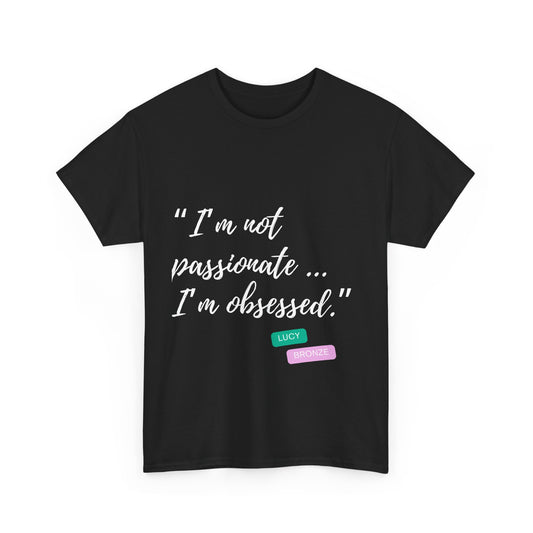 Unisex heavy cotton T-shirt with bold “Not Passion. Obsession.” text design, inspired by the ethos of being Unapologetically Obsessed. Available in charcoal, black, light pink, navy, and sport grey. Emphasizes quality, comfort, and the story of autism and ADHD empowerment tied to the Lioness icon.