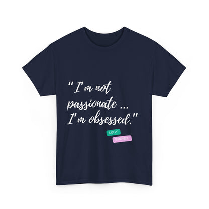 Unisex heavy cotton T-shirt with bold “Not Passion. Obsession.” text design, inspired by the ethos of being Unapologetically Obsessed. Available in charcoal, black, light pink, navy, and sport grey. Emphasizes quality, comfort, and the story of autism and ADHD empowerment tied to the Lioness icon.